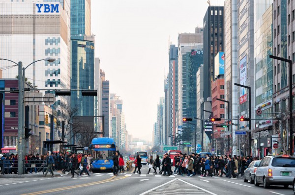 Pedestrians cross the street in the Gangnam district of Seoul, South Korea.