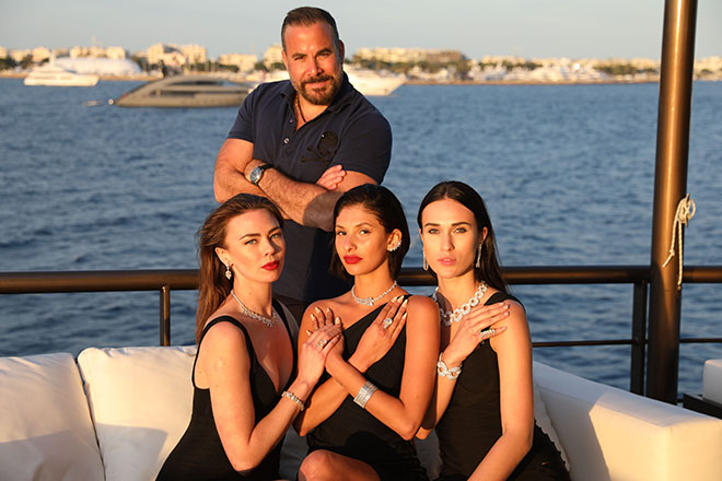 Founder and CEO Samer Halimeh posing with his models on the SSH Maritime Chakra superyacht