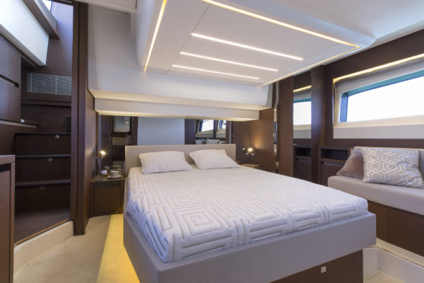 The full-beam master suite enjoys great light from both sides and even features a walk-in wardrobe; Photo © Jean-Marie LIOT / Prestige Yachts