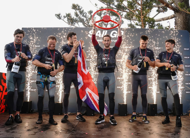 On his event debut, Great Britain helmsman Sir Ben Ainslie (with trophy) celebrates victory at the SailGP Sydney with Iain Jensen, Luke Parkinson, Matt Gotrel, Neil Hunter and Richard Mason